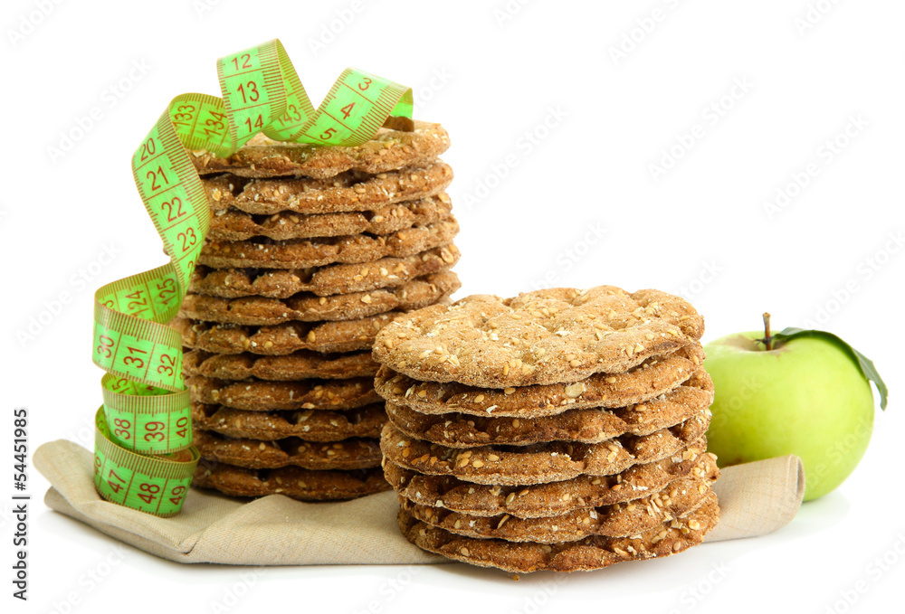 tasty crispbread, apple and measuring tape, isolated on white