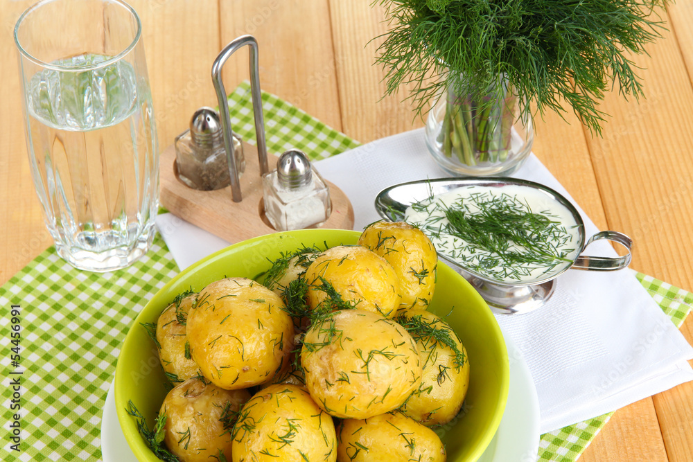 Boiled potatoes on platens on on napkins on wooden table