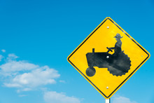 Tractor Crossing Sign With A Sky Blue Background