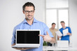 © BlueSkyImages - Men with laptop. Happy young businessman holding a laptop and po