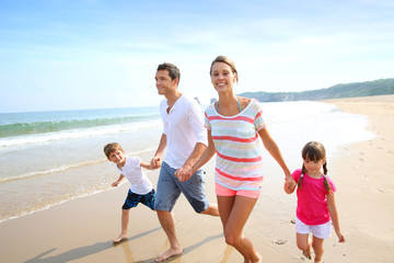 Wall Mural - Happy family running on the beach