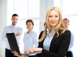 Poster - businesswoman with laptop computer at work