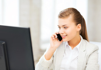 Canvas Print - businesswoman with smartphone in office