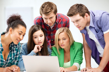 Wall Mural - international students looking at laptop at school