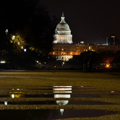 United States Capitol Building at night with reflection over rain pools  - Washington D.C. United States of America