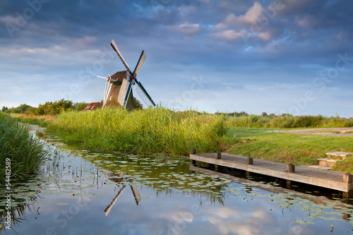 Fototapeta na wymiar windmill reflected in river