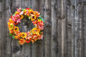 Wall Mural - Autumn flower wreath hanging on rustic wooden fence