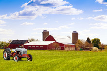 Traditional American Red Farm With Tractor