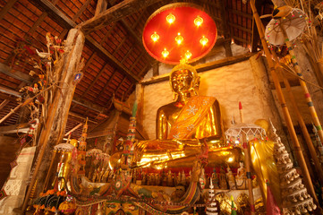 Wall Mural - Golden sitting Buddha in Thai temple.