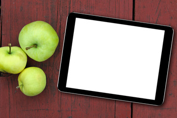 Wall Mural - empty tablet and apples on the red wooden table