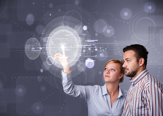 Poster - Happy couple touching abstract high technology circular buttons