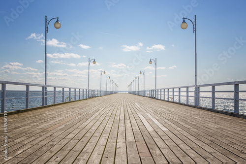 Naklejka na szybę Old empty wooden pier over the sea shore with copy space