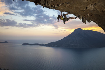 Young female rock climber at sunset, Kalymnos Island, Greece