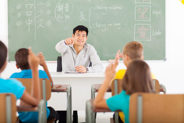 handsome teacher teaching chinese in classroom