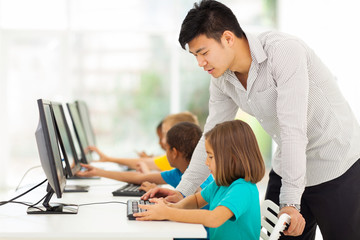 elementary school teacher teaching in computer room