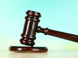 Judges gavel on wooden table on light background