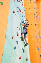 Child Climbing Up The Wall