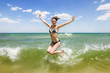 © toshket - Girl jumping and splashing in the waves of the sea