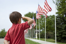 Boy Salutes Flags At Memorial Day Display In A Small Town