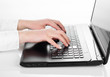 Female fingers typing on the black laptop keyboard