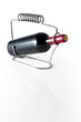 stand with a bottle red wine on a white background