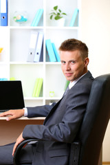 Portrait of young businessman working in office