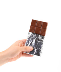 Poster - Hand holds dark chocolate bar in foil.