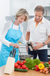 © Andrey Popov - Couple Preparing Food In Kitchen