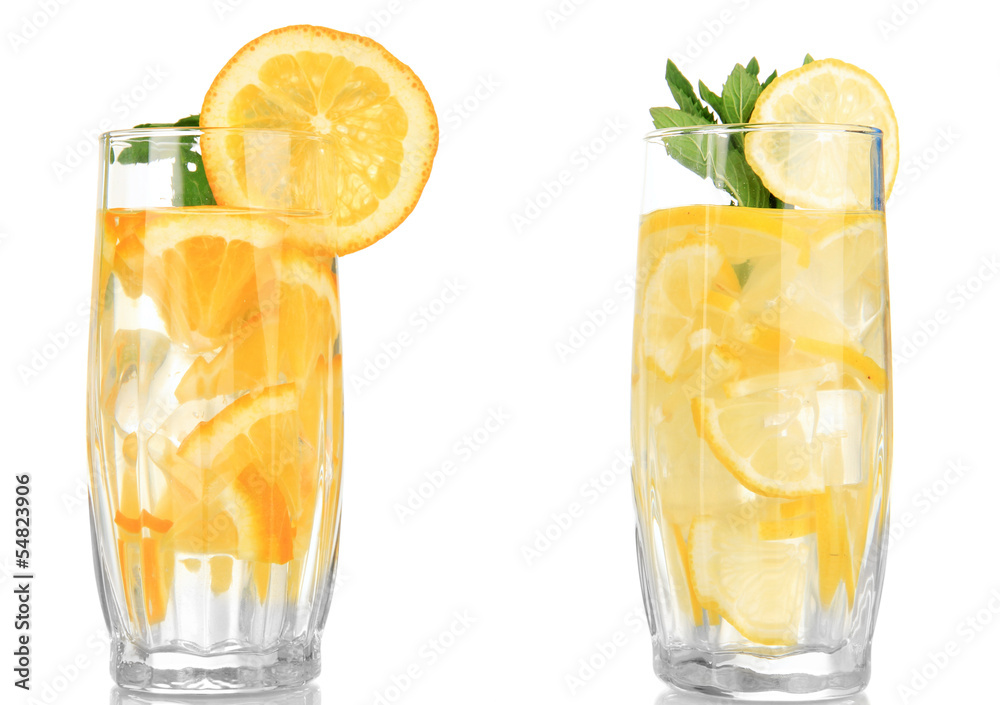 Glasses of fruit drinks with ice cubes isolated on white