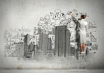 Businesswoman drawing on wall