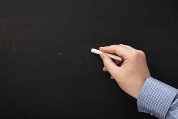 Hand writing on an empty blackboard