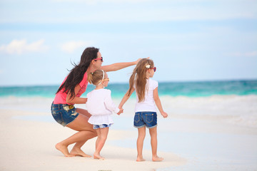 Canvas Print - Young mother and her cute daughters enjoy summer vacation at