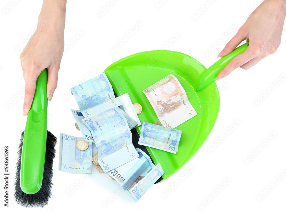 Sweeps money in the shovel on white background close-up