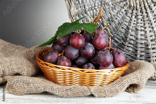 Fototapeta na wymiar Ripe delicious grapes in wicker basket