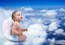 Beautiful Baby Angel Sitting On The Clouds