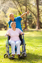 Sticker - nurse taking disabled elderly patient for a walk