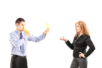 Wall Mural - Young businessman blowing a wistle and showing a yellow card to