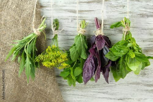 Fototapeta na wymiar Fresh herbs on wooden background