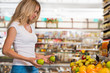 © Milles Studio - Cute happy brunette shopping in a grocery store