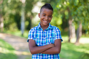 Outdoor portrait of a cute teenage black boy - African people