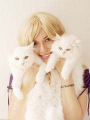 Wall Mural - Girl holding two Persian cats