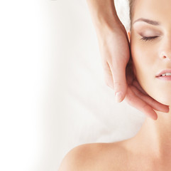 Portrait of a young woman relaxing on a head massage procedure