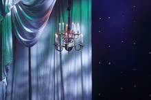 Curtains With Lighting And Chandelier Hanging In Theater