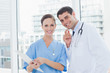 © WavebreakmediaMicro - Cheerful surgeon and doctor posing while working together