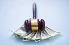 Gavel And Dollars On A Blue Background
