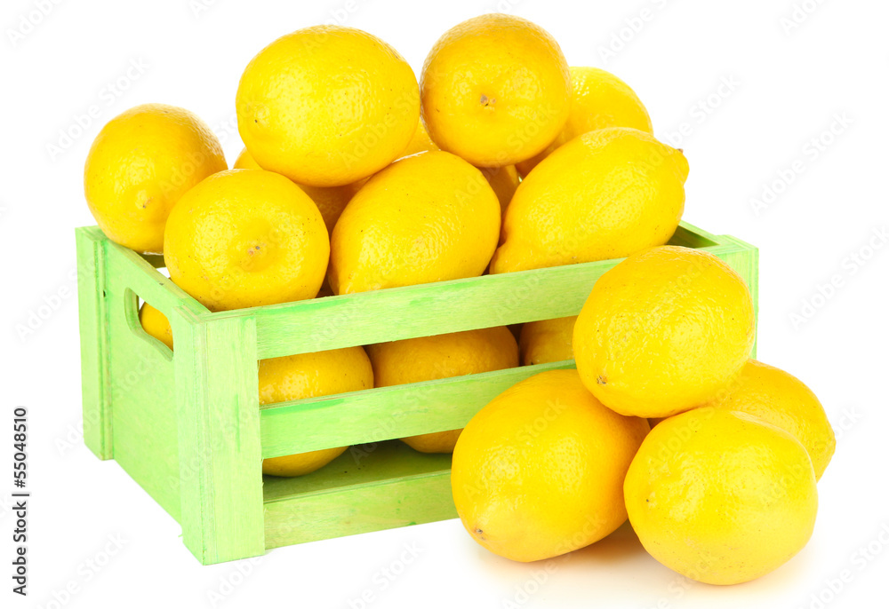 Ripe lemons in wooden box isolated on white