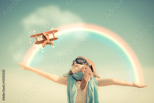 Naklejka na drzwi Happy kid playing with toy airplane