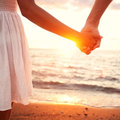 Wall Mural - love - romantic couple holding hands, beach sunset