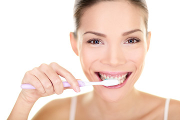 Wall Mural - Woman brushing teeth holding toothbrush