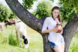 © stormy - Young happy woman drinking fresh milk near cows in countryside